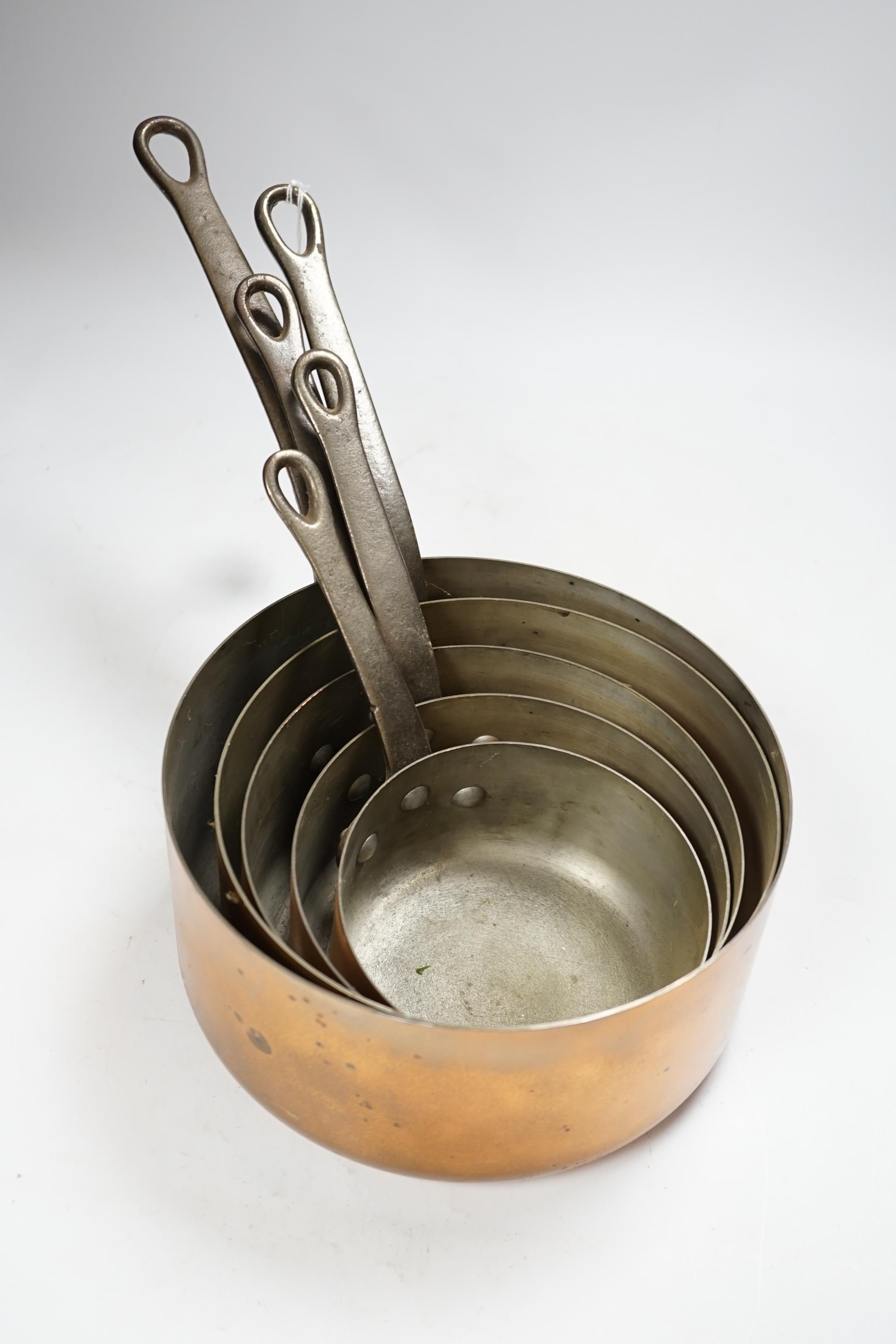 A set of five French graduated copper saucepans, signed Faucogney